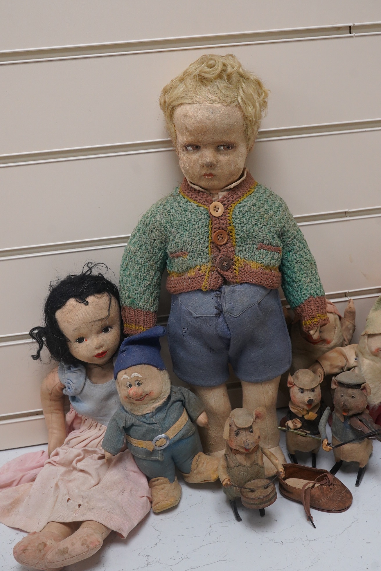 A Merrythought Hygienic Toys Snow White and the seven dwarves, three Schuco clockwork pig musicians and a felt doll. Condition - fair.